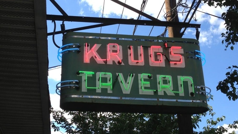 The neon sign for Krug's Tavern