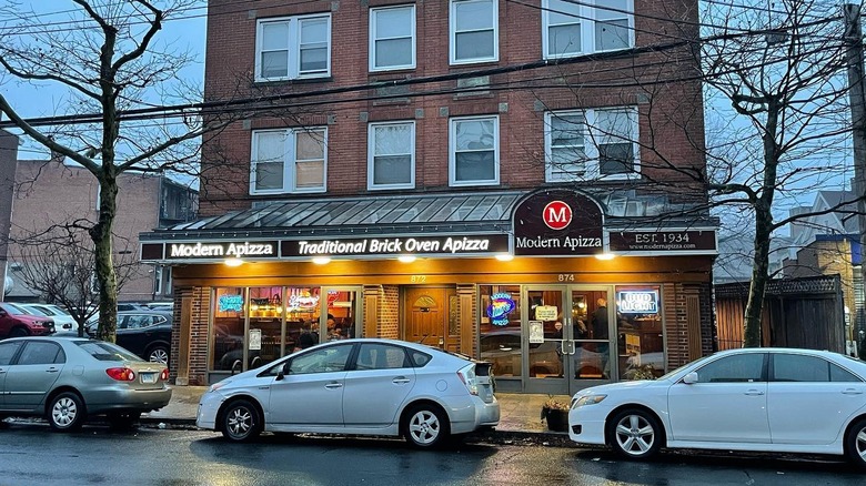 The exterior of Modern Apizza in New Haven with cars parked out front