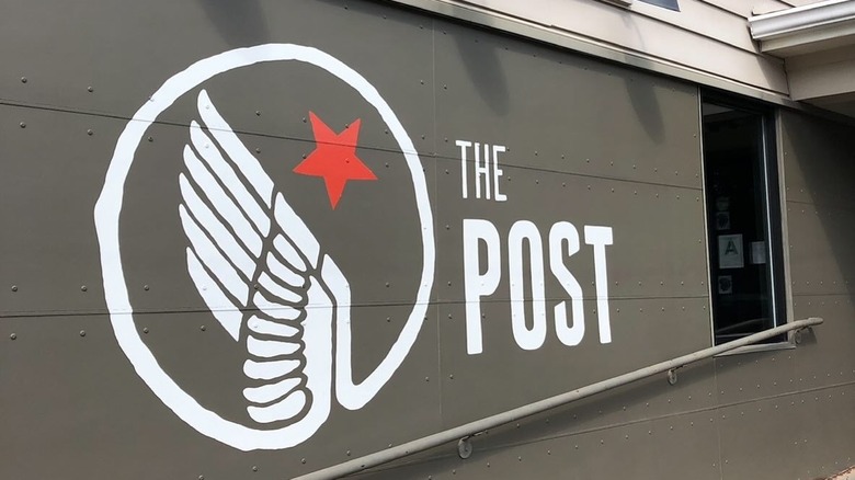 Sign painted on the wall of The Post pizza place