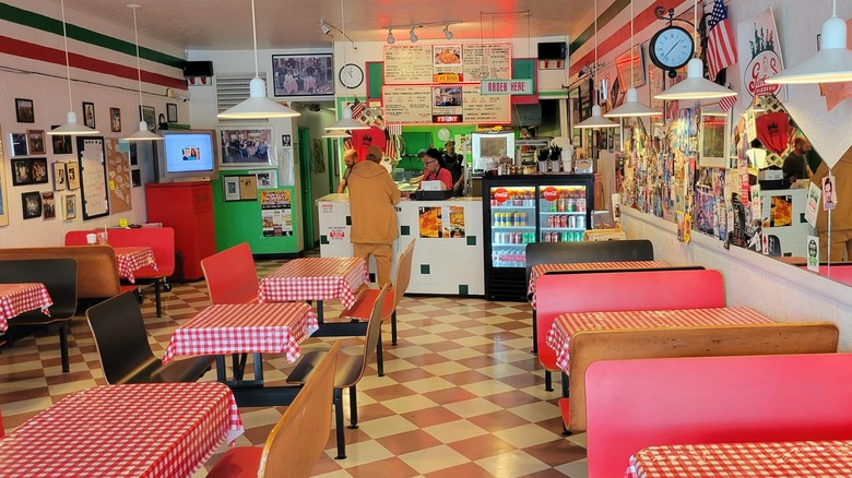 Interior of Giovanni's Pizzeria with red booth seats and red and white checkered tablecloths