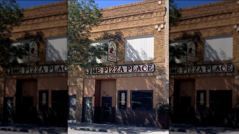 The red brick exterior of The Pizza Place
