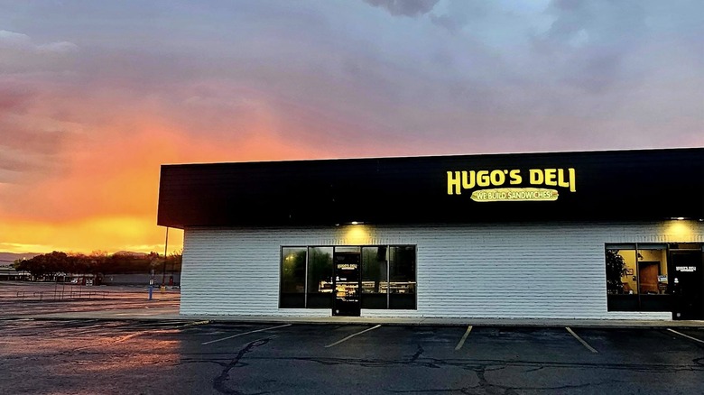 Exterior of Hugo's Deli at sunset