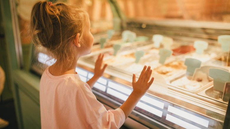 Little girl looking into an ice cream display