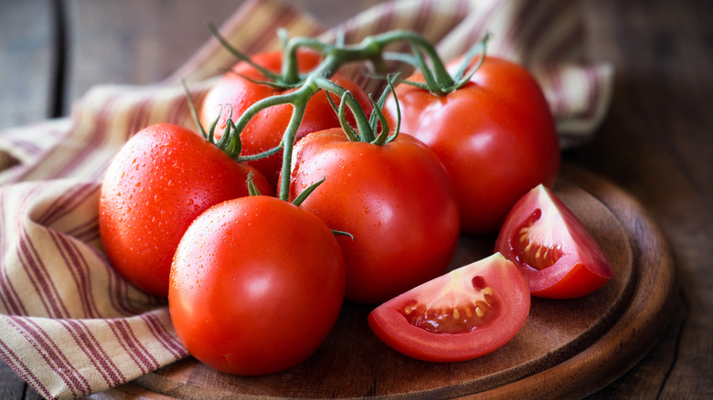 fresh tomatoes on wooden platter