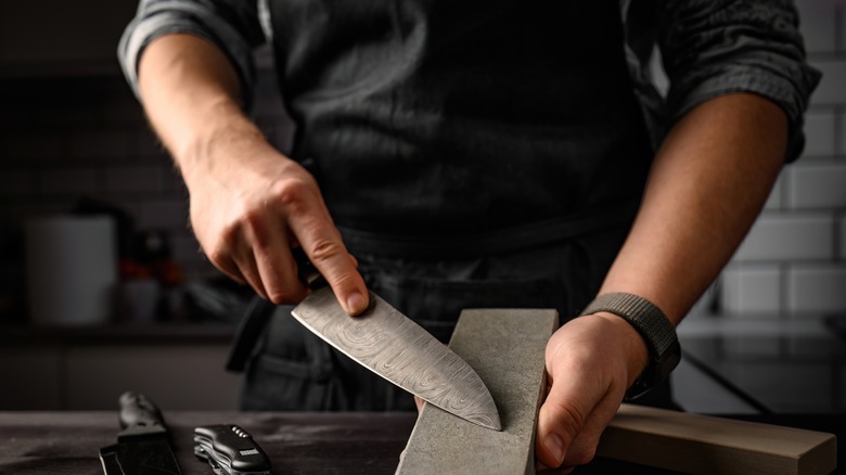 sharpening a knife on a stone