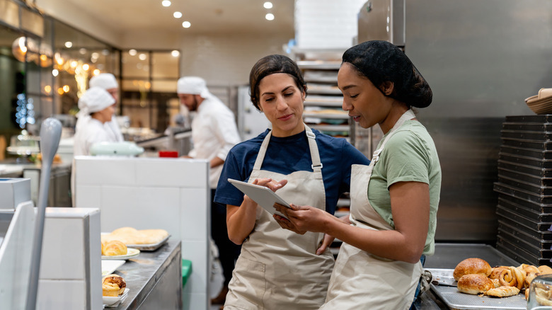 Pastry chefs look at an ipad