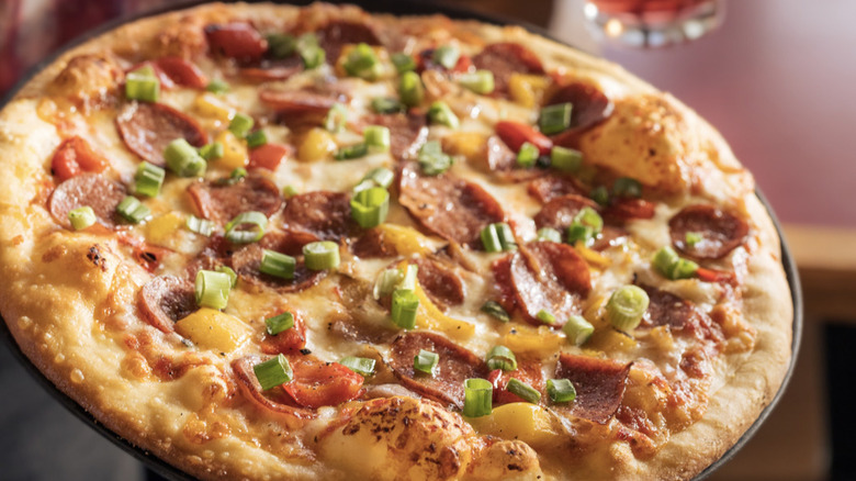 Wood-fired pizza with pepperoni and scallions