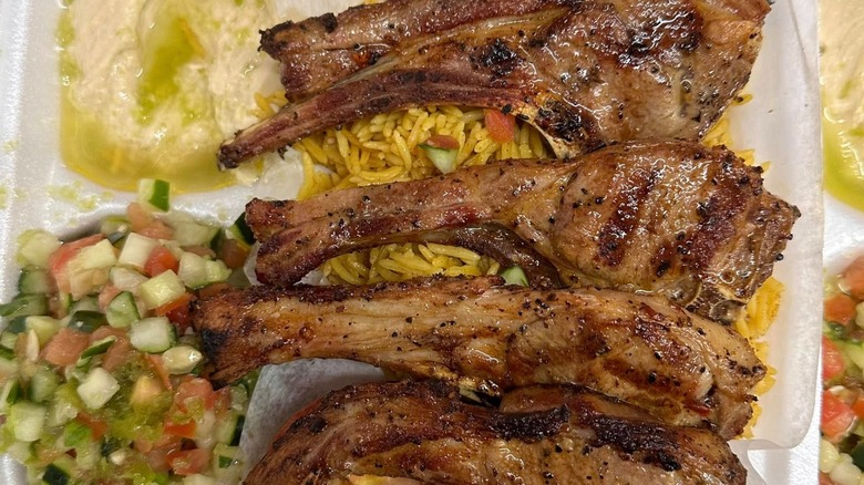 Lamb chops on rice with hummus and veg
