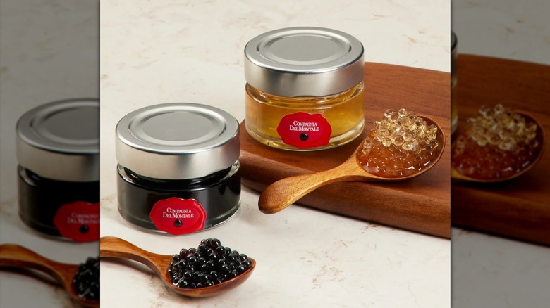 Two tins of white and balsamic vinegar pearls.