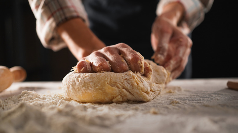 A cook kneading dough