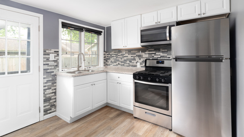 A compact gray and white kitchen