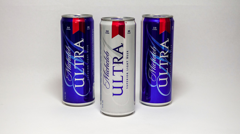 Three cans of Michelob Ultra on a white background.