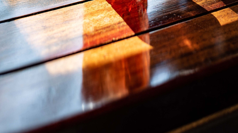 Close-up of a Negroni being spritzed with orange peel