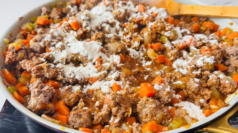 Shepherd's pie filling with flour sprinkled on top