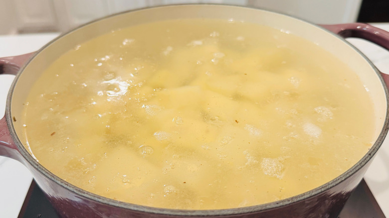 Chopped potatoes in large pot of water