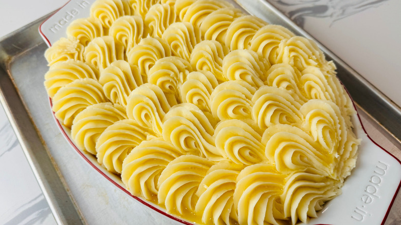 Shepherd's pie in baking dish inside of baking sheet
