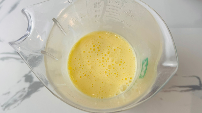 Beaten eggs in measuring cup