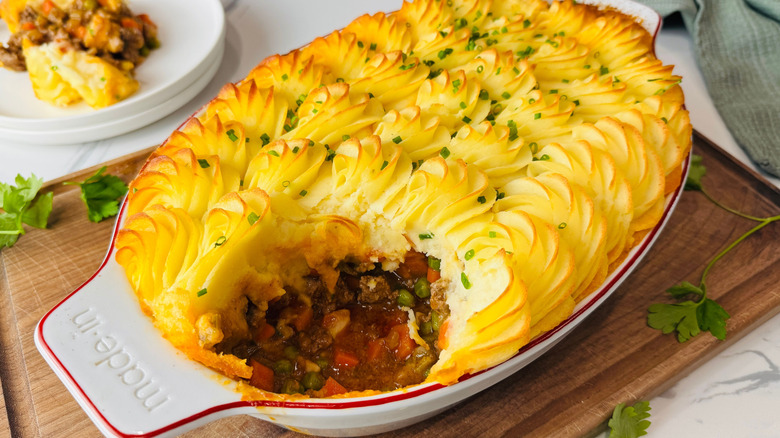 Shepherd's pie in baking dish with scoop removed