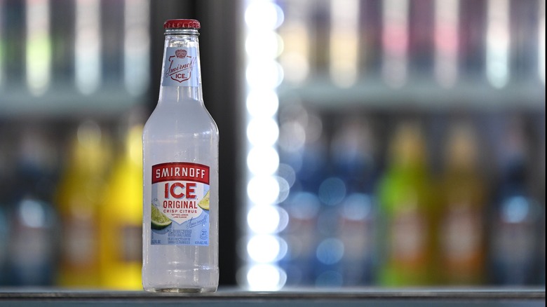 bottle of smirnoff ice displayed in front of chiller