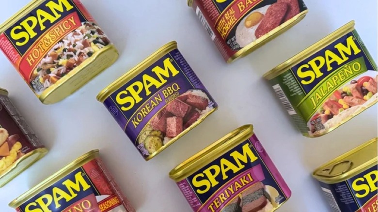Cans of Spam against a white background.
