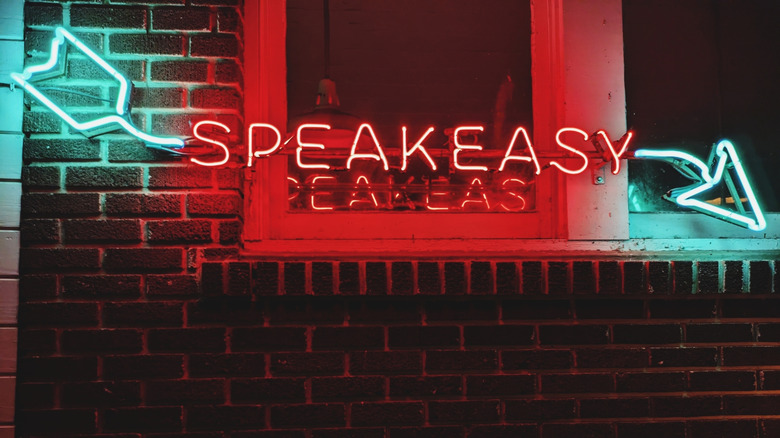 Neon sign reading "speakeasy" with an arrow