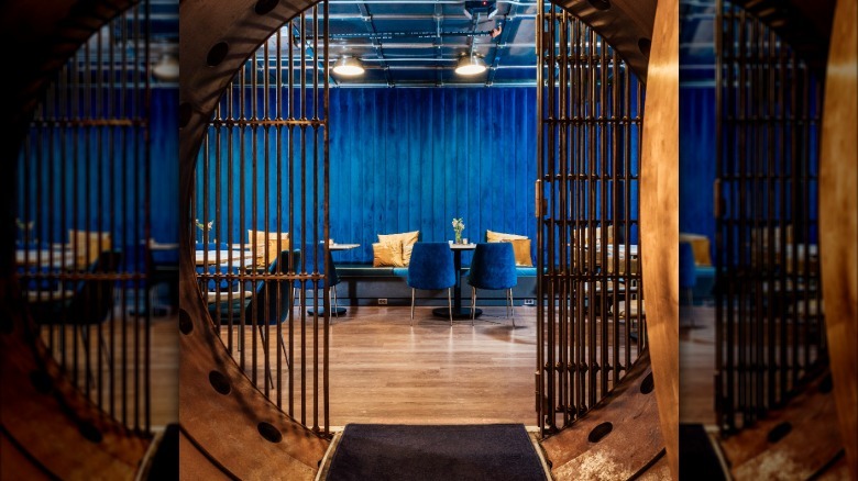 Blue walls and chairs behind an iron grate