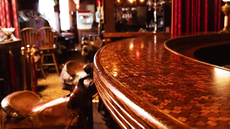 Bar counter and saddle stools at Saddle Rock Saloon & Speakeasy