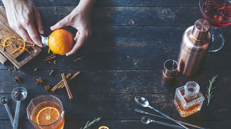 Oranges, star anise, cinnamon, and other spices used by a bartender