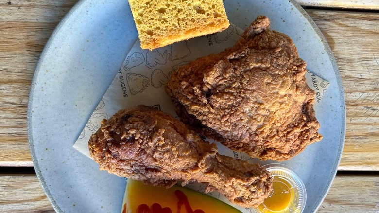 Fried chicken on plate with cornbread.