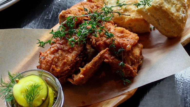 Fried chicken with cornbread and side of dill pickles.
