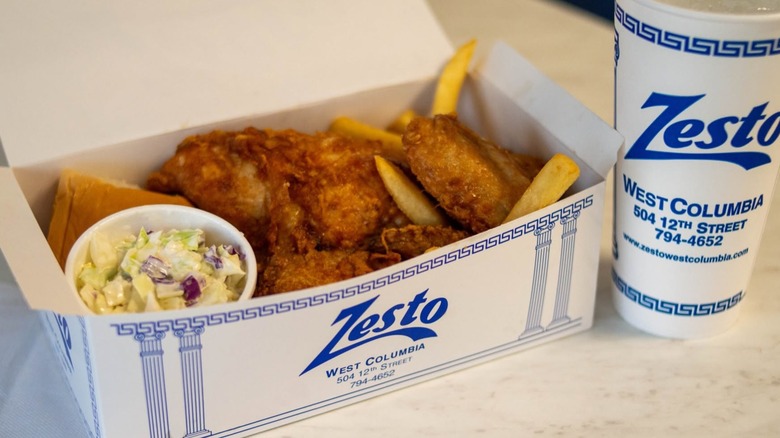 Fried chicken, fries, and slaw in Zesto box with drink.