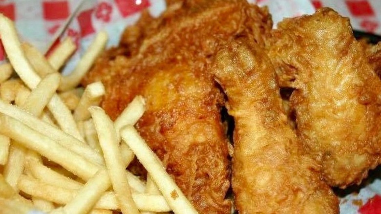 Fried chicken and fries on paper.