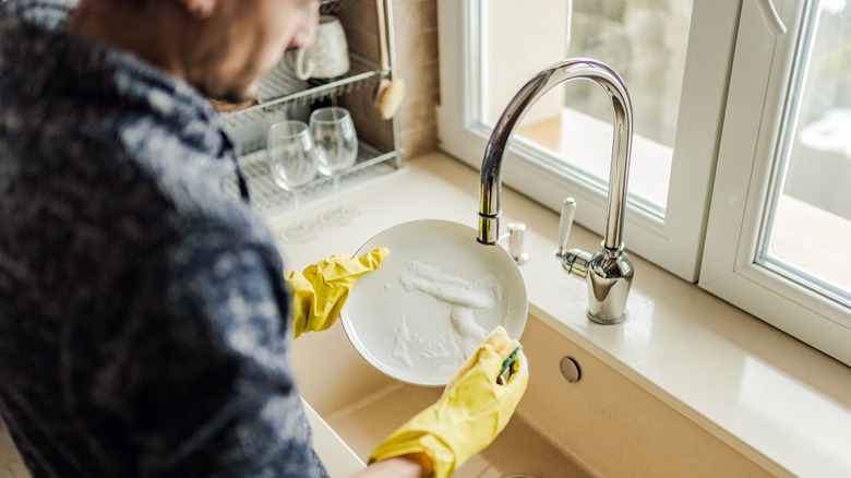 man washing dishes