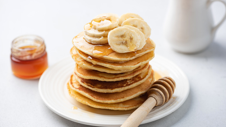 a stack of pancakes topped with bananas