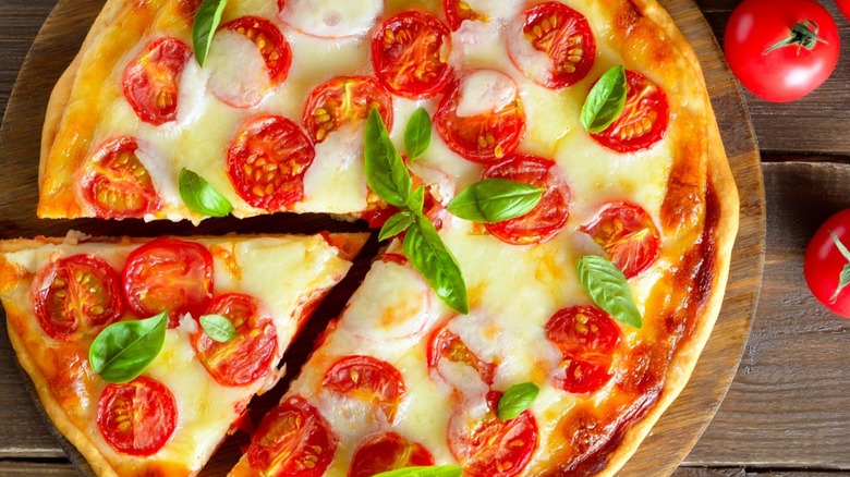 Whole pizza with tomatoes