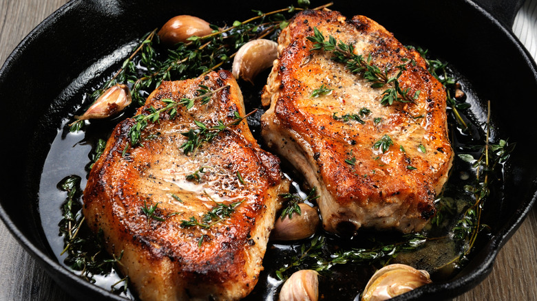 Pork steaks in a cast iron pan.