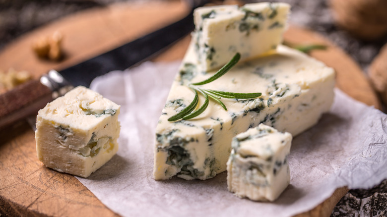 Slice of French Roquefort cheese on wax paper