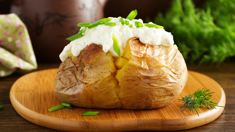 fluffy baked potato garnished with chives