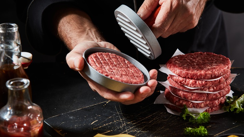 Chef prepping ground beef patties