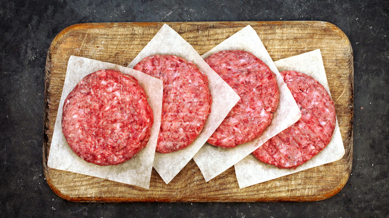 Ground beef patties on board