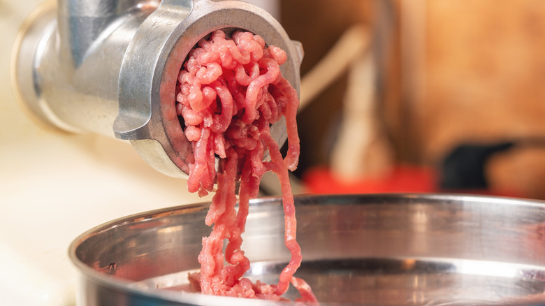 ground beef coming out of a meat grinder