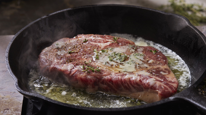 Steak in pan with oil