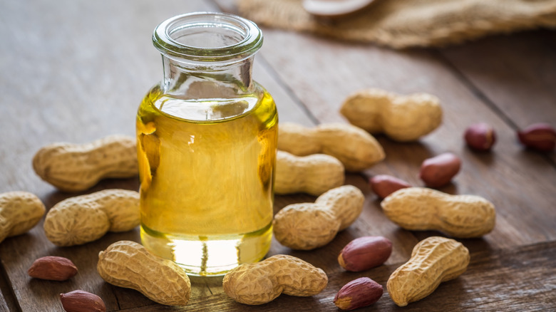 Bottle of oil with peanuts