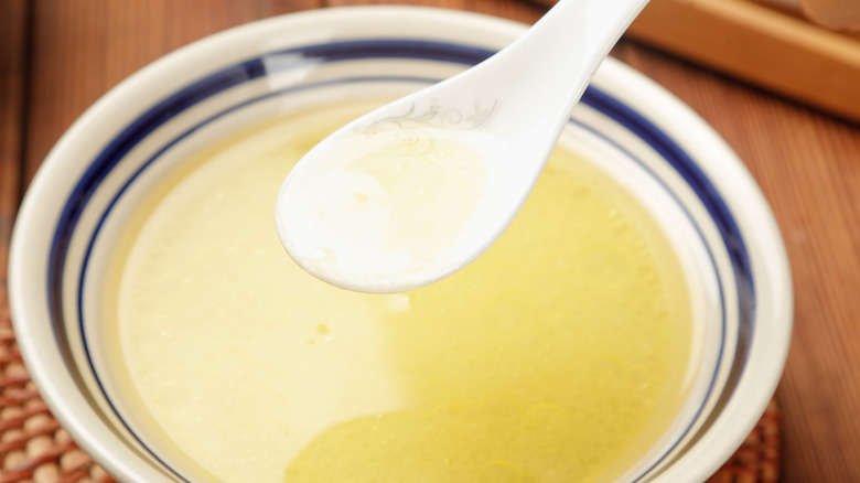 Bowl of schmaltz oil and a spoon