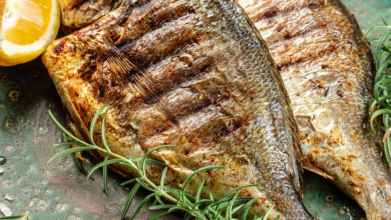 grilled walleye on platter with seasonings
