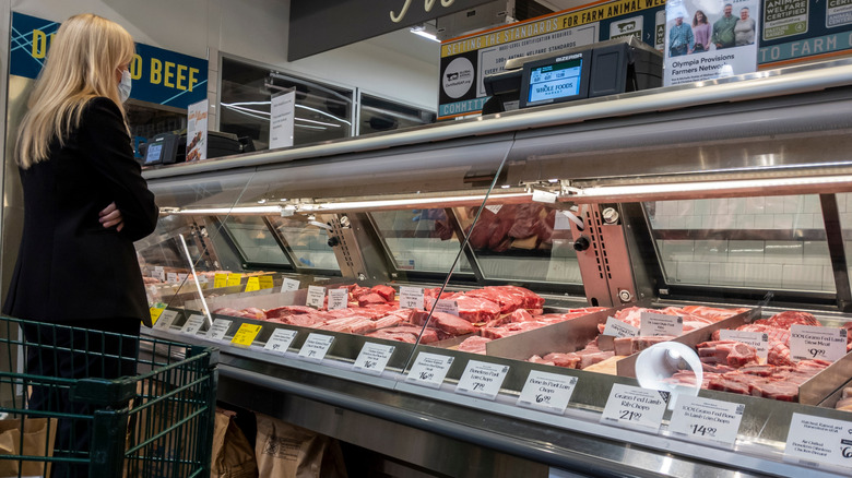 Woman standing ready to be helped at Whole Foods meat counter