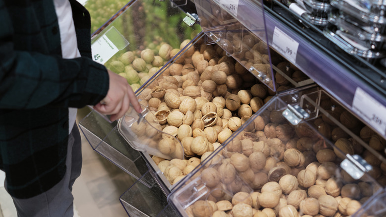 Bulk bins in a grocery store showing pistachios