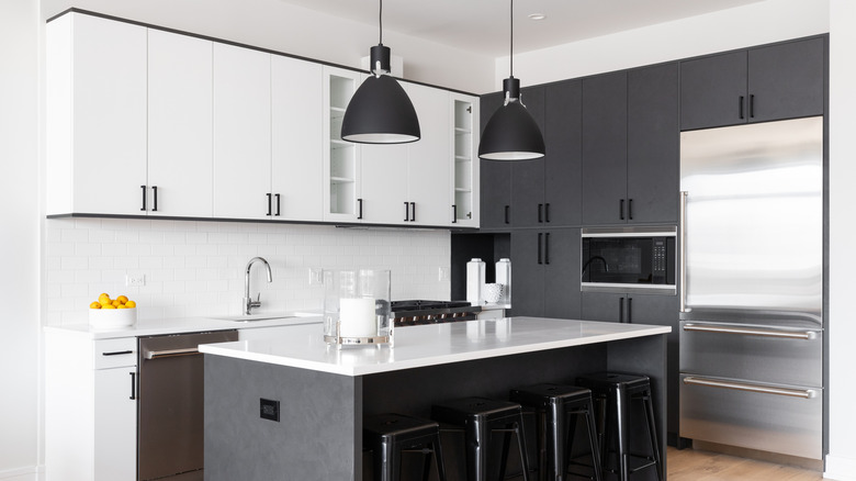 black and white kitchen with lighter upper cabinets
