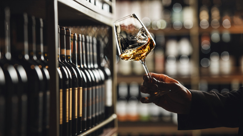 A sommelier swirling a wine glass