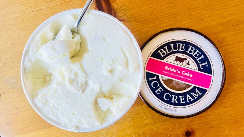 Blue Bell Bride's Cake ice cream tub with a spoon